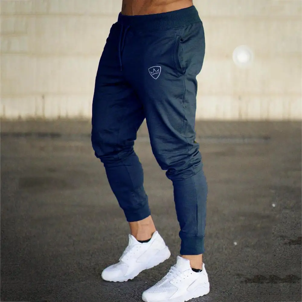 Vīriešu ikdienas sporta darbojas vaļīgas bikses spēcīgu kabatas, elastīga vidukļa zeķes skriešanas bikses gadījuma bikses sporta bikses mācību jogg