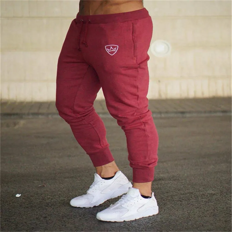 Vīriešu ikdienas sporta darbojas vaļīgas bikses spēcīgu kabatas, elastīga vidukļa zeķes skriešanas bikses gadījuma bikses sporta bikses mācību jogg